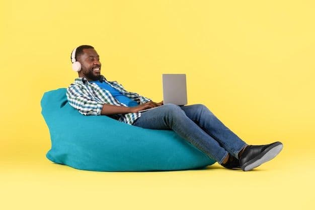 Person relaxing on a bean bag with laptop